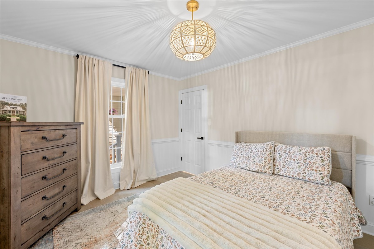 Charming bedroom with boho light fixture and wainscoting